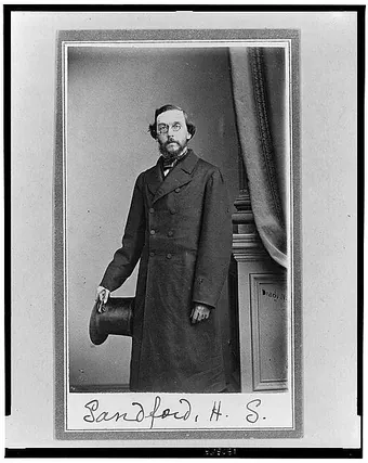 Studio portrait of Henry Shelton Sanford standing, in a dark suit, around 1860