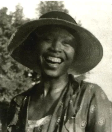 Black-and-white portrait of Zora Neale Hurston wearing a hat