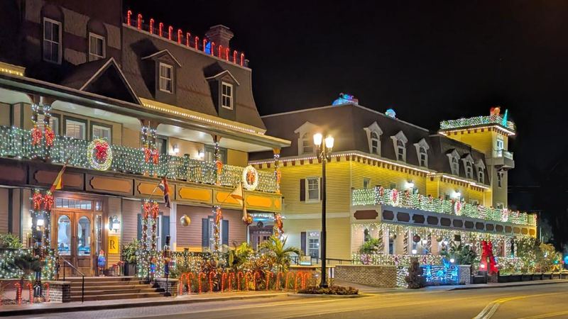 Historic St. Augustine buildings wrapped in holiday lights at night